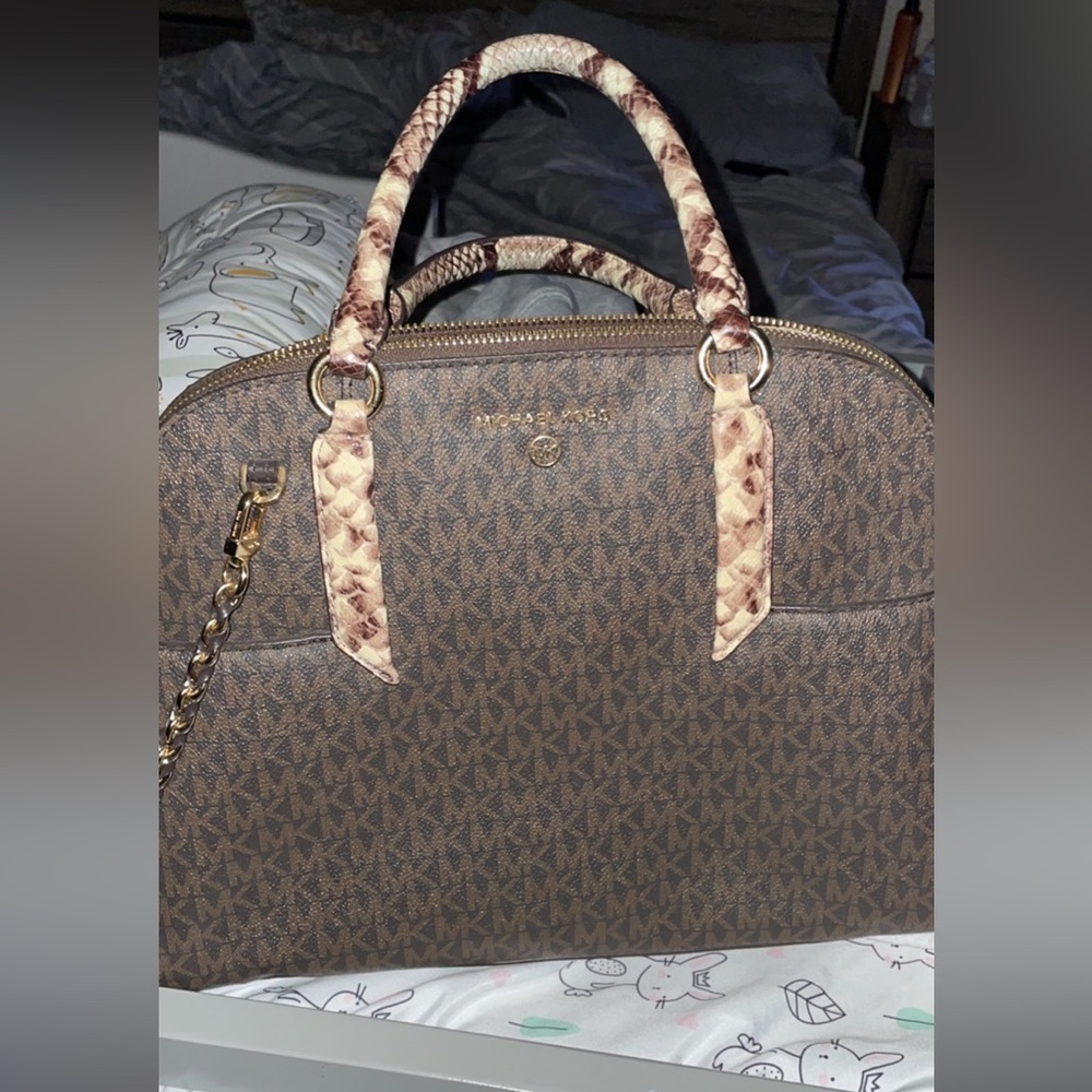 MK logo with snake skin handle